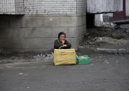 North Korean woman selling ice creams in the street, Kangwon Province, Wonsan, North Korea