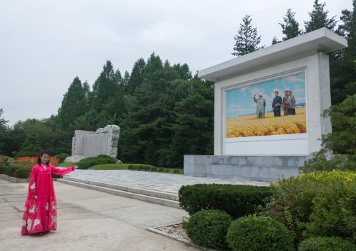 North Korean guide showing a fresco with the Dear Leaders, South Hamgyong Province, Hamhung, North Korea