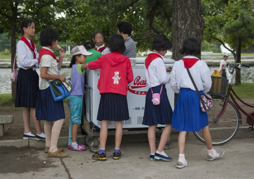 Ice cream street vendor with pioneers in Songdowon international children's union camp, Kangwon Province, Wonsan, North Korea