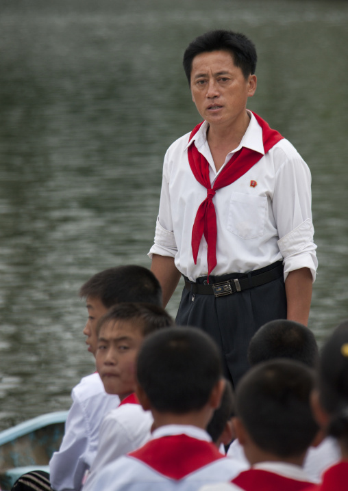 North Korean pioneers in a rowing boat with a leader in Songdowon international children's union camp, Kangwon Province, Wonsan, North Korea