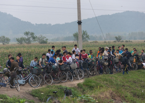 North Korean children with their bicycles going to do collective works in the fields, Kangwon Province, Wonsan, North Korea