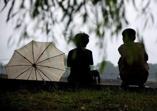 Silhouettes of a North Korean couple sit together, South Hamgyong Province, Hamhung, North Korea