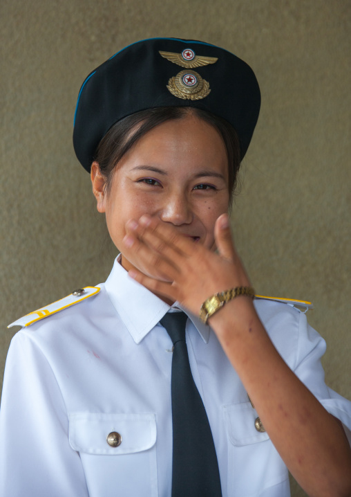 Shy North Korean airport employee laughing, South Hamgyong Province, Hamhung, North Korea