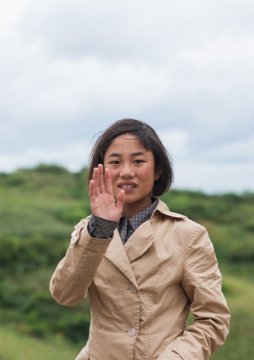 North Korean teenage girl waving hand, North Hamgyong Province, Jung Pyong Ri, North Korea