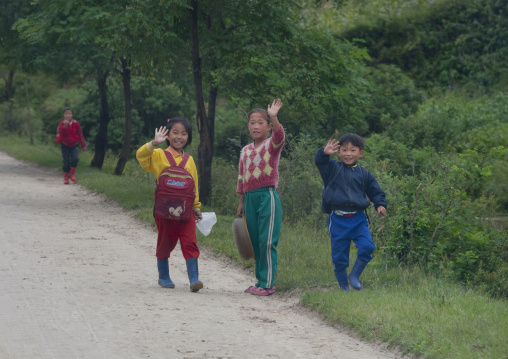 North Korean children waving on a road, North Hamgyong Province, Jung Pyong Ri, North Korea