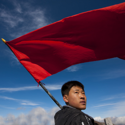 North Korean student with red flag in mount Paektu, Ryanggang Province, Mount Paektu, North Korea