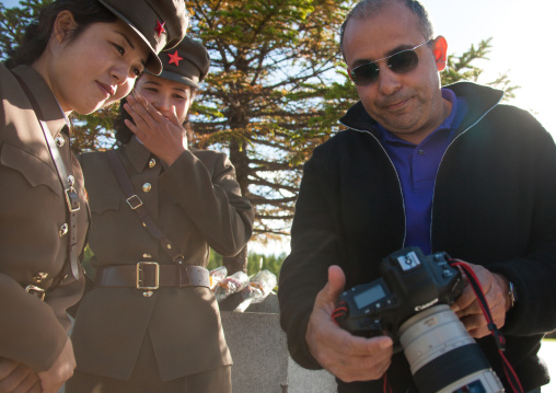 North Korean soldiers watching the camera screen of a tourist, Ryanggang Province, Samjiyon, North Korea