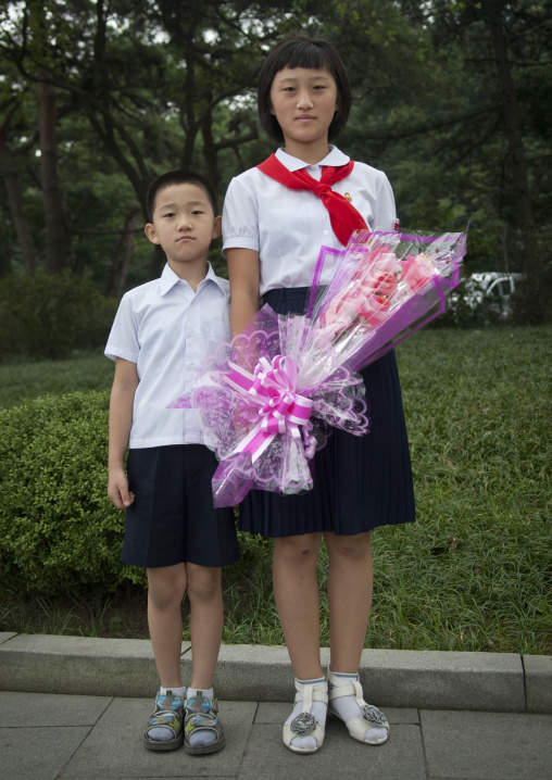 North Korean children with flowers at Kim il Sung Mangyongdae native house, Pyongan Province, Pyongyang, North Korea