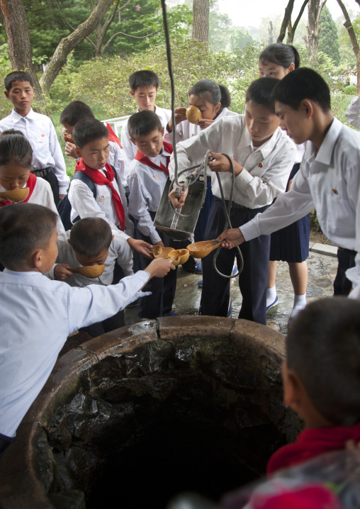 Children drinking from a well at Kim il Sung Mangyongdae native house, Pyongan Province, Pyongyang, North Korea