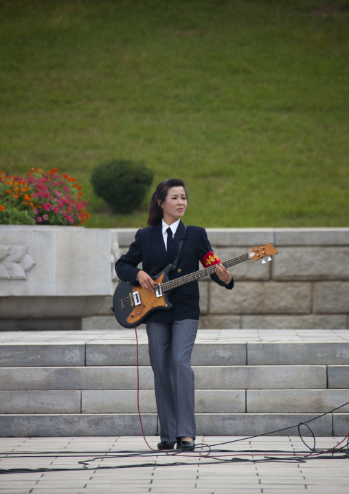North Korean young woman playing bass in a park, Pyongan Province, Pyongyang, North Korea
