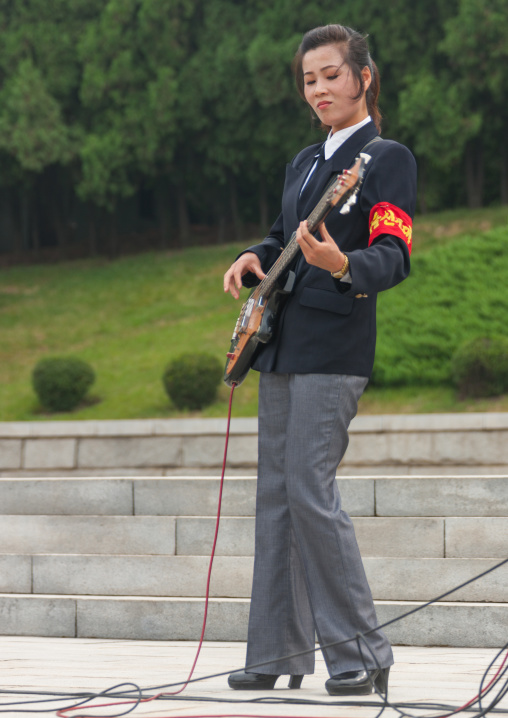 North Korean state artist playing bass on national day, Pyongan Province, Pyongyang, North Korea