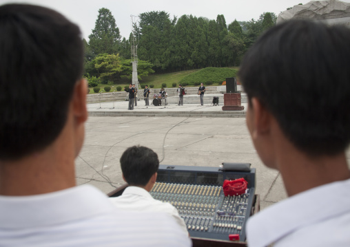 North Korean people listening to a band playing music on national day in the street, Pyongan Province, Pyongyang, North Korea