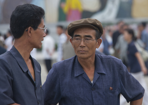Two North Korean men chatting in the street, Pyongan Province, Pyongyang, North Korea
