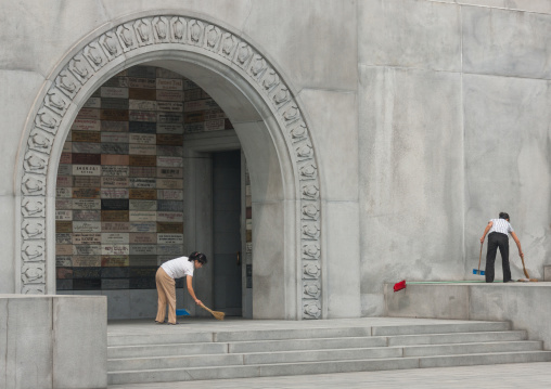 North Korean women sweeping a tthe bottom of the Juche tower, Pyongan Province, Pyongyang, North Korea