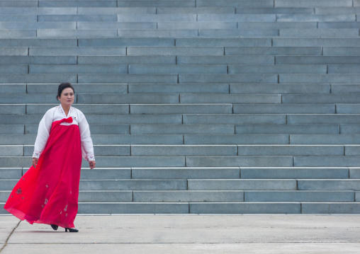 Portrait of a North Korean woman in traditional choson-ot in front of large stairs, Pyongan Province, Pyongyang, North Korea