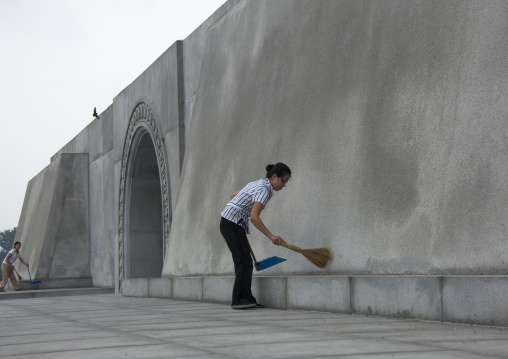 North Korean woman sweeping a tthe bottom of the Juche tower, Pyongan Province, Pyongyang, North Korea
