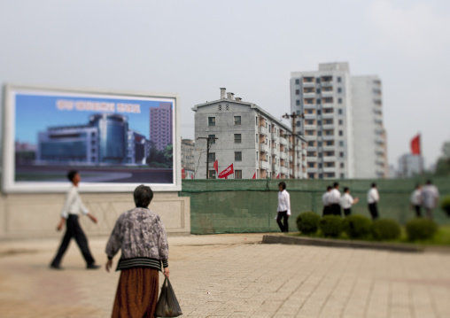 North Korean people walking in front of propaganda billboards, Pyongan Province, Pyongyang, North Korea