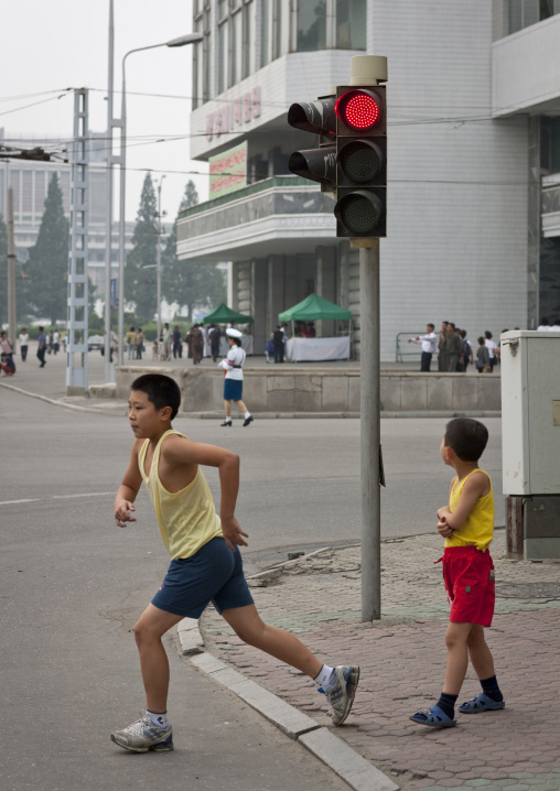 North Korean boys crossing a street under a traffic light, Pyongan Province, Pyongyang, North Korea