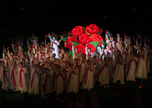 North Korean women dancing in front of a giant Kimilsungia flower during the Arirang mass games in may day stadium, Pyongan Province, Pyongyang, North Korea