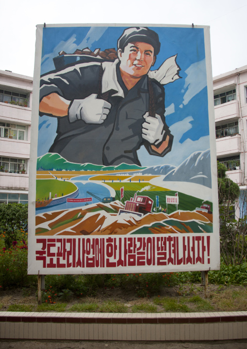 Large propaganda billboard with a smiling worker, North Hwanghae Province, Kaesong, North Korea