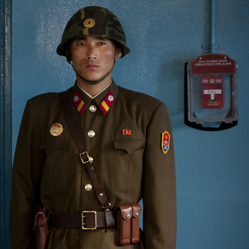 North Korean soldier wearing an helmet standing in front of the United Nations conference rooms on the demarcation line in the Demilitarized Zone, North Hwanghae Province, Panmunjom, North Ko