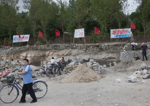 North Korean cyclists and workers in the street, North Hwanghae Province, Kaesong, North Korea
