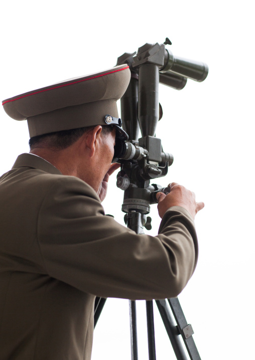 North Korean officer looking south Korea with binoculars at the Demilitarized Zone, North Hwanghae Province, Panmunjom, North Korea