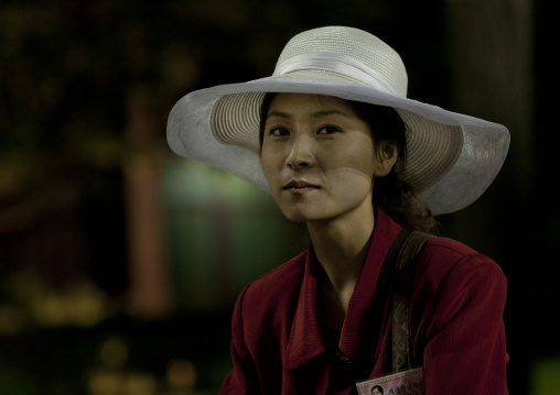 Portrait of a North Korean woman with a large hat at the Kaeson youth park, Pyongan Province, Pyongyang, North Korea
