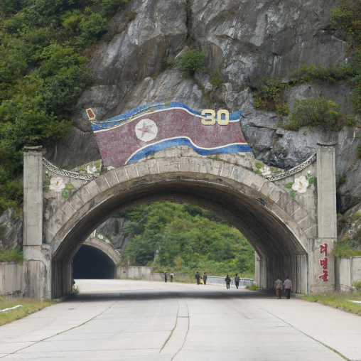 Tunnel in rocky mountain with a North Korea flag above, Kangwon Province, Wonsan, North Korea