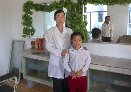 North Korean haidresser with a child, South Pyongan Province, Chonsam Cooperative Farm, North Korea