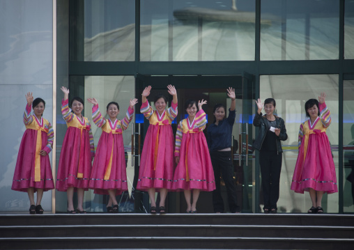 North Korean saleswomen waving their hands in front of the shop entrance, Kangwon-do, Kumgang, North Korea
