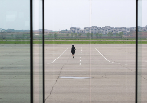 North Korean airport employee on the tarmac in Sunan international airport, Pyongan Province, Pyongyang, North Korea
