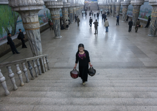 Young North Korean woman climbing stairs in Yonggwang station, Pyongan Province, Pyongyang, North Korea