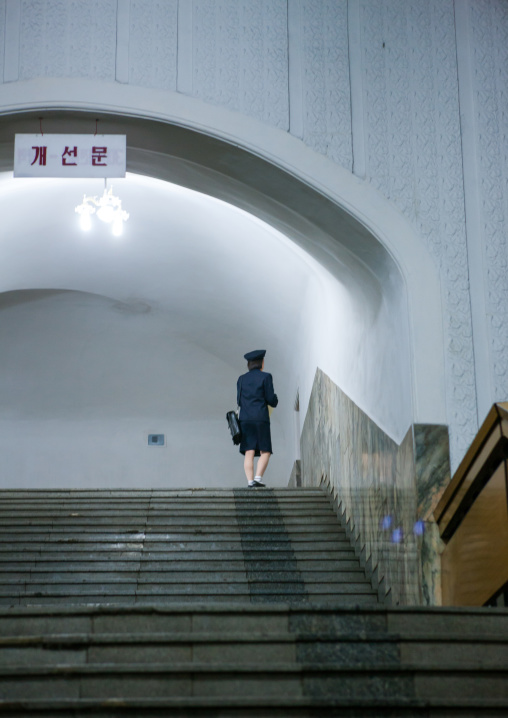North Korean woman employee at top of stairs in a subway station
, Pyongan Province, Pyongyang, North Korea