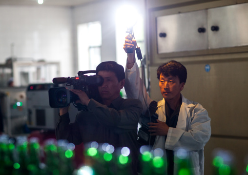 North Korean tv crew filming at kangso yaksu mineral water factory, South Pyongan Province, Nampo, North Korea