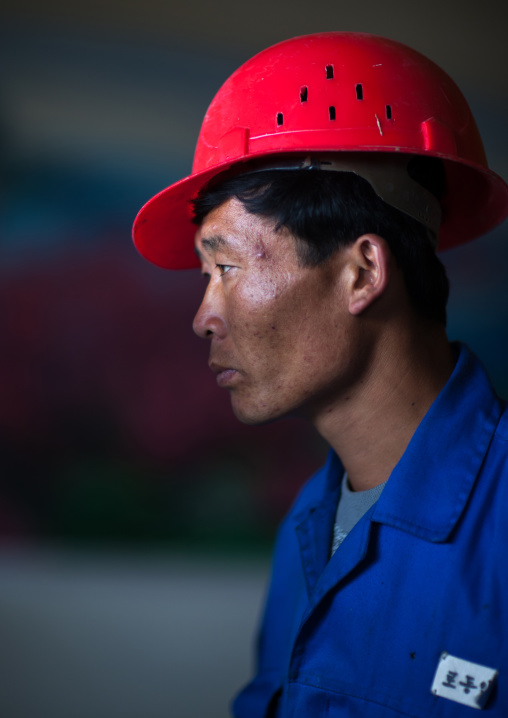 North Korean worker with a red helmet in a steel factory, South Pyongan Province, Nampo, North Korea