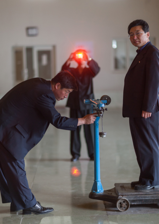 North Korean man on a weighing machine in a factory
, South Pyongan Province, Nampo, North Korea