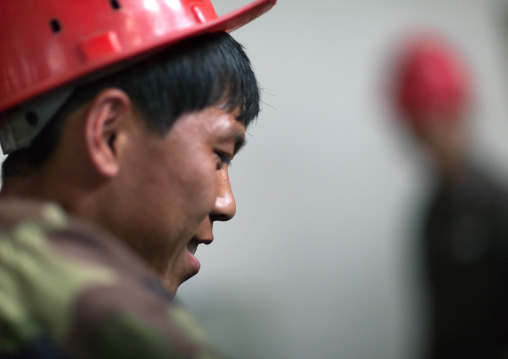 North Korean worker with a red helmet in a steel factory, South Pyongan Province, Nampo, North Korea
