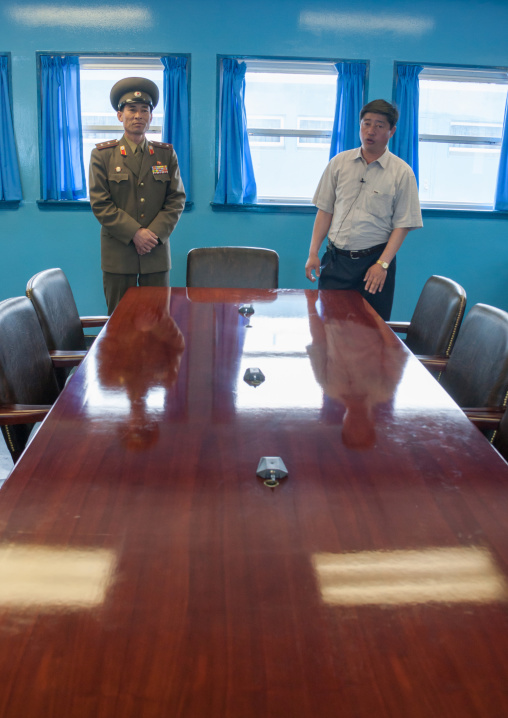 North Korean soldier and a guide in the conference room of the United Nations on the demarcation line in the Demilitarized Zone, North Hwanghae Province, Panmunjom, North Korea