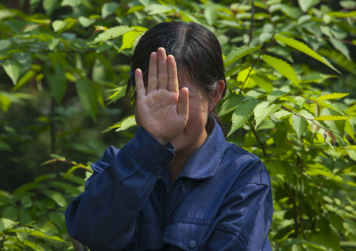 North Korean woman hidding her face with her hand, North Hwanghae Province, Kaesong, North Korea
