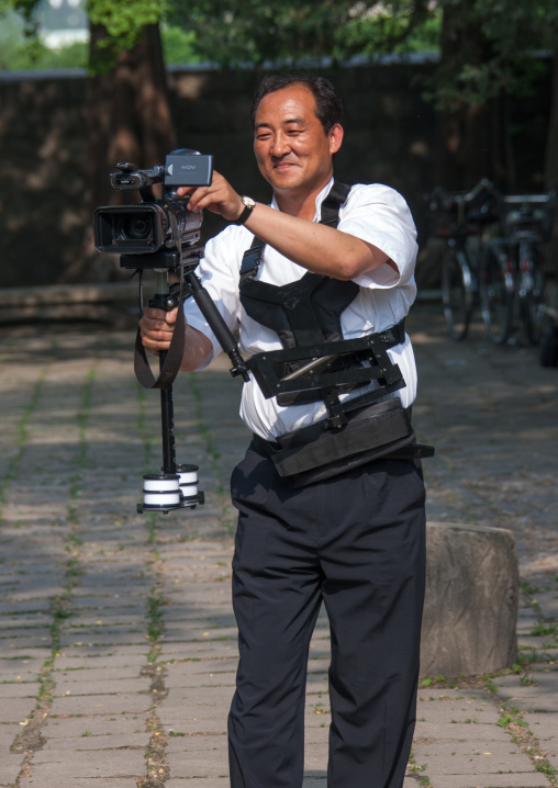 Portrait of a North Korean television cameraman with a steadycam, North Hwanghae Province, Kaesong, North Korea