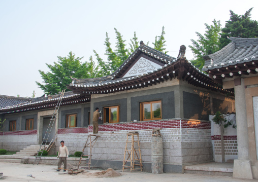 Workers repairing a house in folk hotel, North Hwanghae Province, Kaesong, North Korea