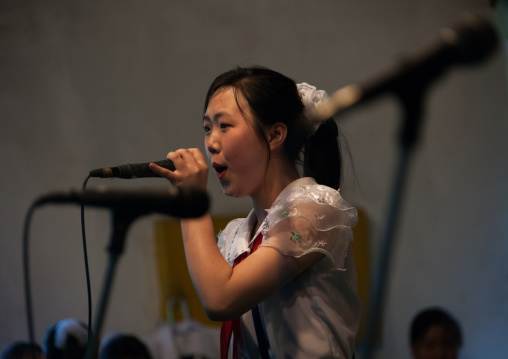 North Korean pioneer girl singing during a show for tourists, Pyongan Province, Pyongyang, North Korea