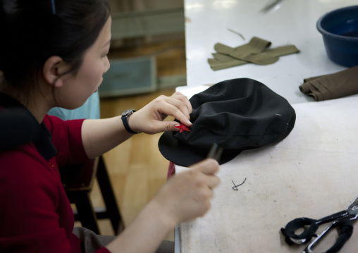 North Korean tailor woman making a military cap, Pyongan Province, Pyongyang, North Korea