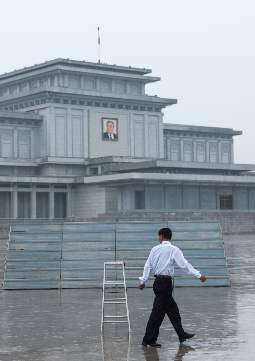 North Korean man under the rain in Kumsusan memorial palace, Pyongan Province, Pyongyang, North Korea