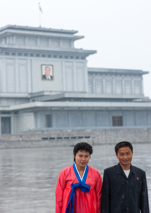 North Korean couple under the rain in Kumsusan memorial palace, Pyongan Province, Pyongyang, North Korea