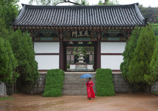 North Korean woman with an umbrella in Kwangbok temple, Pyongan Province, Pyongyang, North Korea