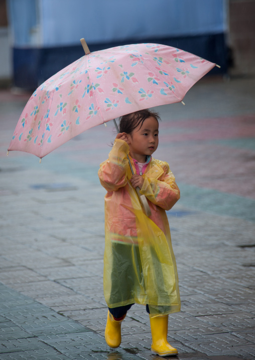North Korean girl with an umbrella in the street, Pyongan Province, Pyongyang, North Korea