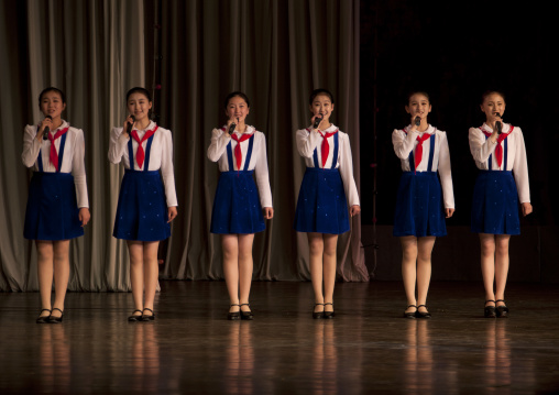 North horean pioneers girls singing during a show at Mangyongdae children's palace, Pyongan Province, Pyongyang, North Korea