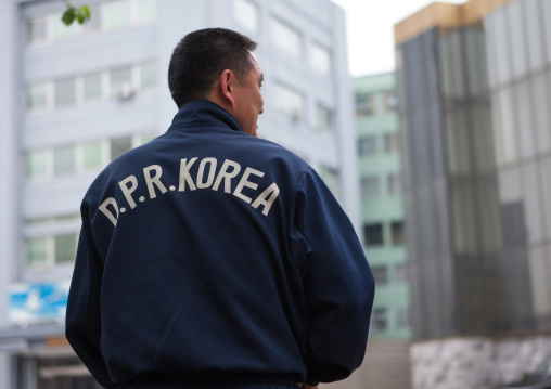 North Korean coach wearing a sport sweatsuit tagged with dprk in the back, Pyongan Province, Pyongyang, North Korea